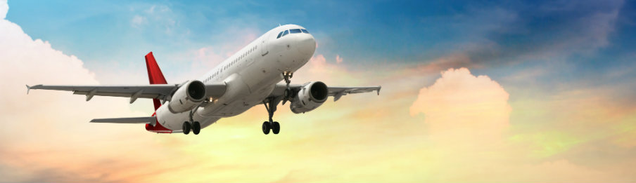 airplane flying at sunset
